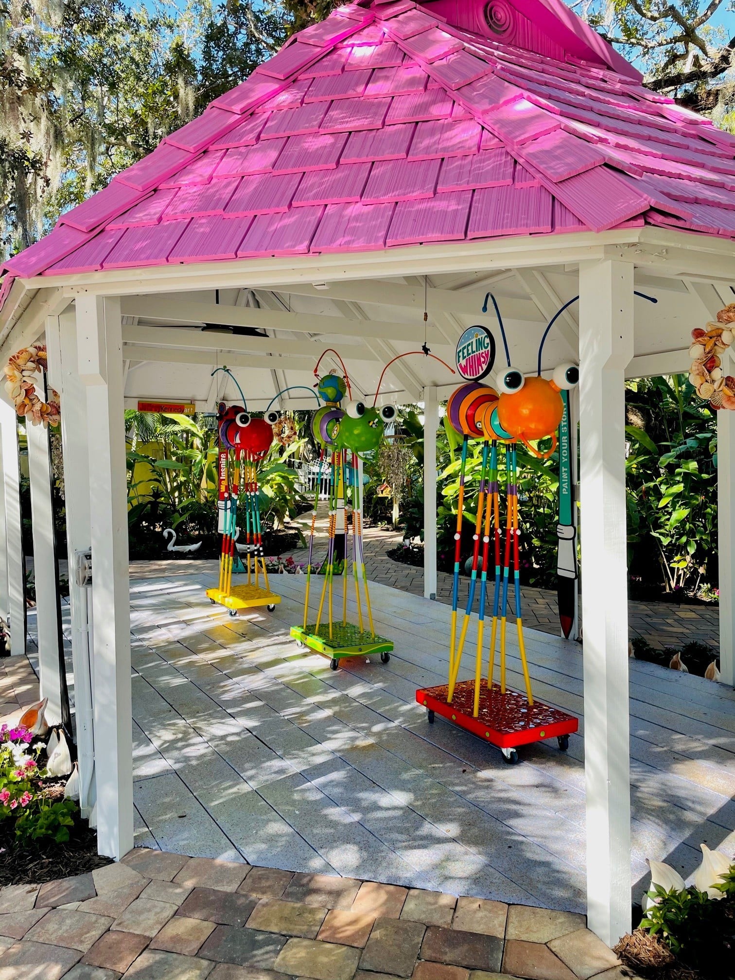 A Gazebo With A Pink Roof And Swings In Vibrant Colors